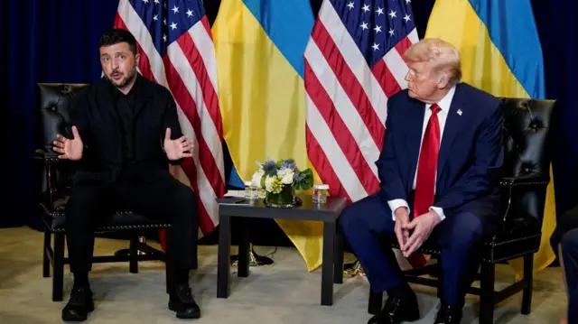 Zelensky and Trump sat together in front of Ukrainian and US flags