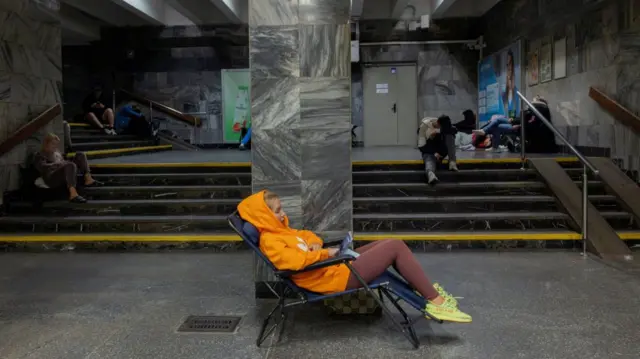 People take shelter in a metro station during a Russian drone attack on Ukraine, in Kyiv, Ukraine