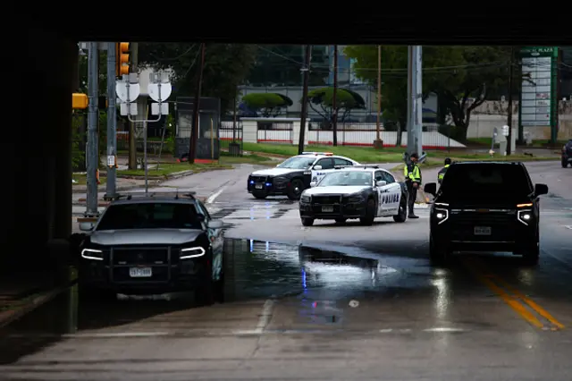 Law enforcement officers work near the scene of a shooting near a US Immigration and Customs Enforcement (ICE) detention facility in Dallas, Texas
