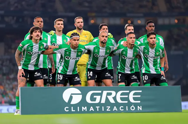 Real Betis players line up before a match