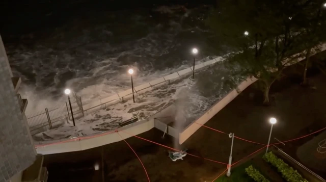 A screengrab from a video that was shot during the early morning of Wednesday showing waves breaking over a wall in Hong Kong