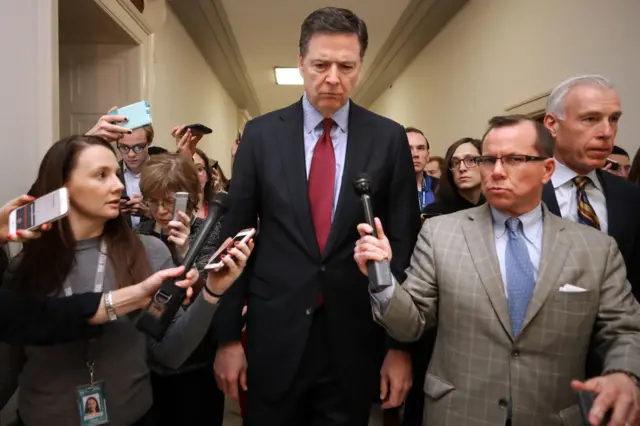 Former Federal Bureau of Investigation Director James Comey is surrounded by reporters after testifying to the House Judiciary and Oversight and Government Reform committees at the Rayburn House Office Building on Capitol Hill December 07, 2018 - Getty