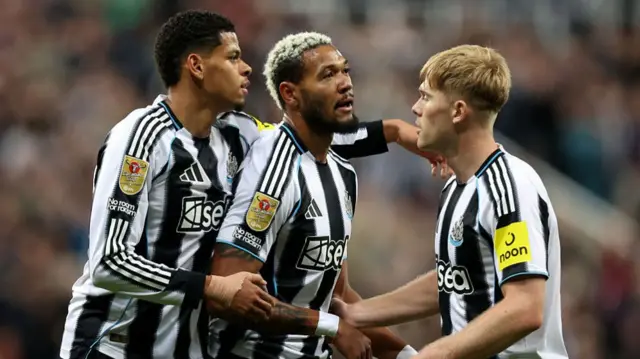 Joelinton celebrates scoring his team's first goal with William Osula (L) and Lewis Hall (R)