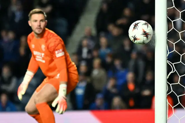 Rangers' English goalkeeper #01 Jack Butland watches as a shot from KRC Genk's Slovak midfielder #17 Patrik Hrosovsky (unseen) rebounds off of the post during the UEFA Europa League, league stage football match between Rangers and Genk at the Ibrox Stadium in Glasgow