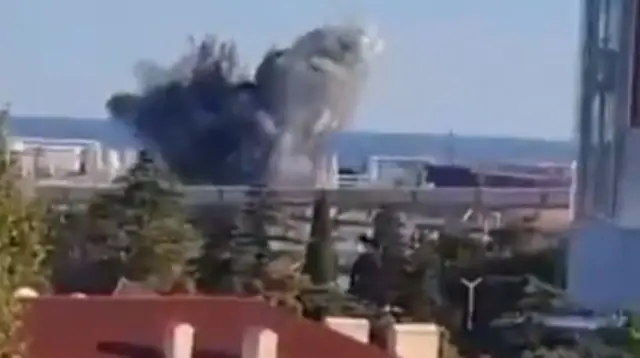 a screengrab showing an explosion at a dockside pier at the port of Tuapse