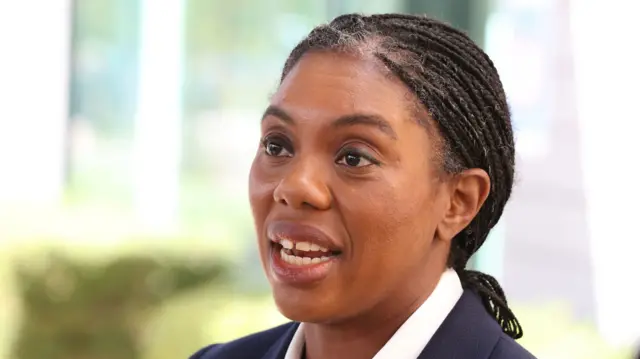 A headshot of Kemi Badenoch mid-speaking
