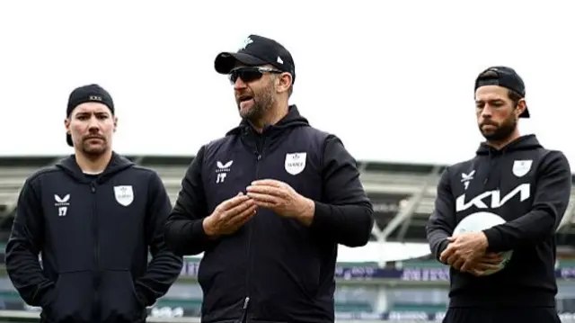 Surrey assistant coach Jim Troughton talks to coaching staff