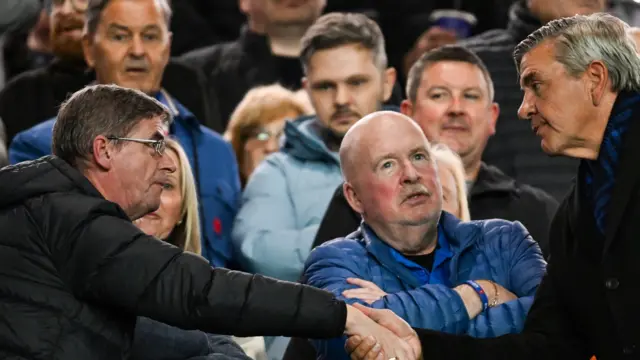 Rangers chairman Andrew Cavenagh shakes the hand of a Rangers fan during a UEFA Europa League match between Rangers and KRC Genk at Ibrox Stadium