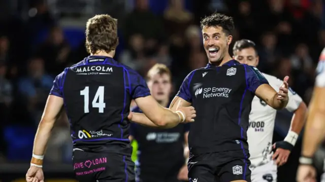 Adam Hastings celebrates with Kyle Rowe