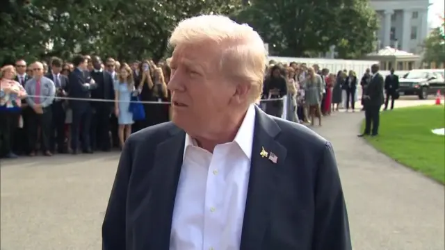 Trump outside the White House with onlookers behind him