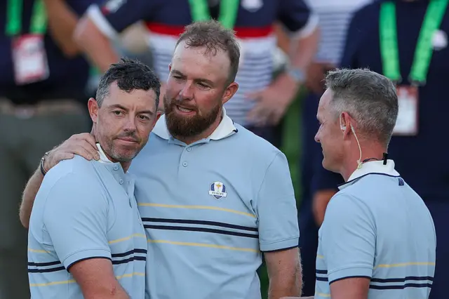 Rory McIlroy and Shane Lowry with Team Europe captain Luke Donald at the end of day one of the 2025 Ryder Cup