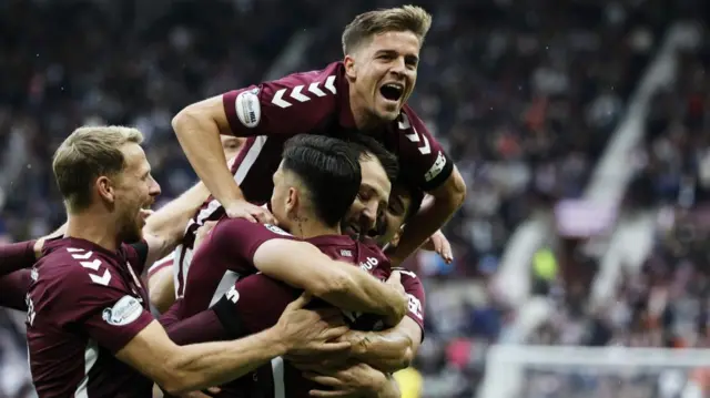 Hearts Craig Halkett celebrates with Cammy Devli after scoring to make it 3-0