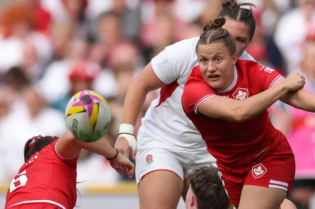 Canada's scrum half Justine Pelletier passes the ball