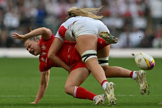 Canada's scrum-half Justine Pelletier (L) is tackled by England's flanker Zoe Aldcroft