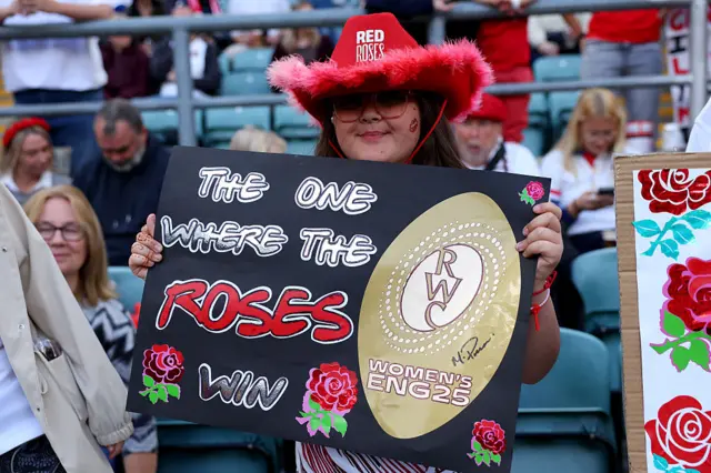 A fan holding a sign