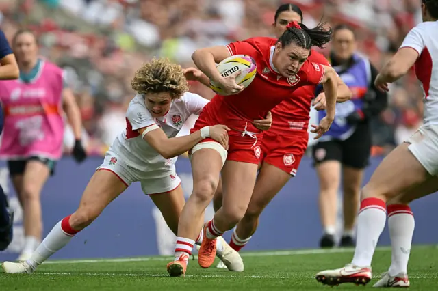 Canada's wing Alysha Corrigan (R) is tackled