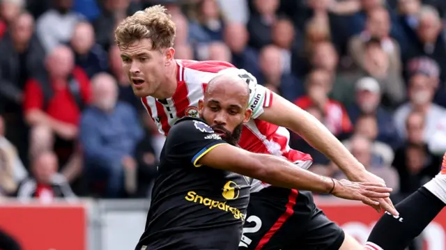 Nathan Collins of Brentford fouls Bryan Mbeumo of Manchester United
