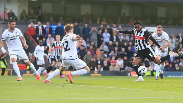 Jayden Sweeney (second right) draws his leg back to strike the ball and score