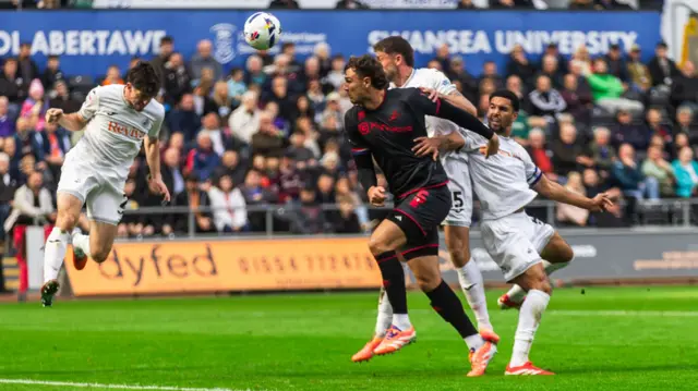 Swansea City FC's defender Josh Key (2) heads clear from Millwall FC defender Jake Cooper (C)