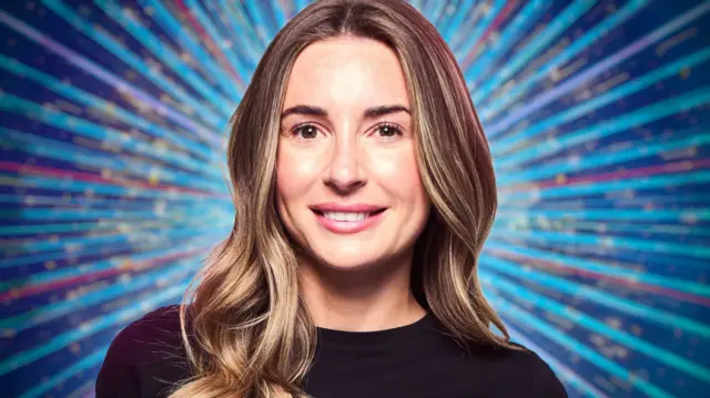 Dani Dyer Strictly headshot with show's glittering background of blues and pink. She has her hair open and is wearing a black top