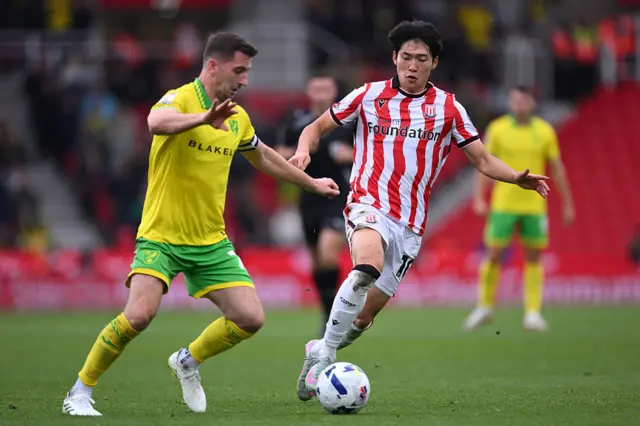 Bae Jun-Ho of Stoke City is challenged by Kenny McLean of Norwich City