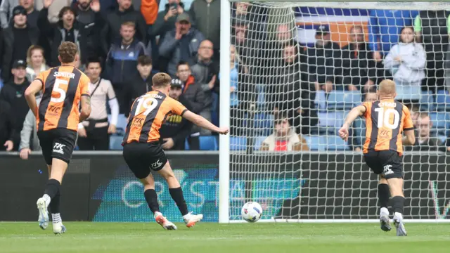 Mark Shelton kicks the ball from the penalty spot