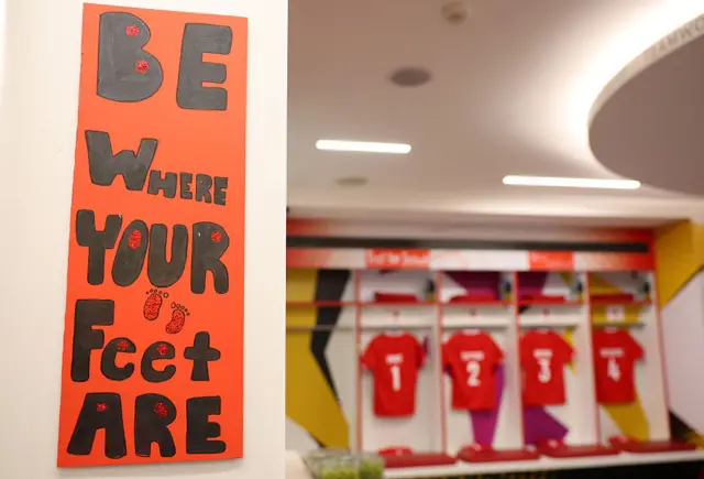 Canada's changing room with a sign saying 'be where your feet are'