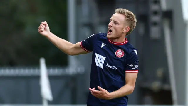 Harvey White clenches his right fist as he celebrates a goal