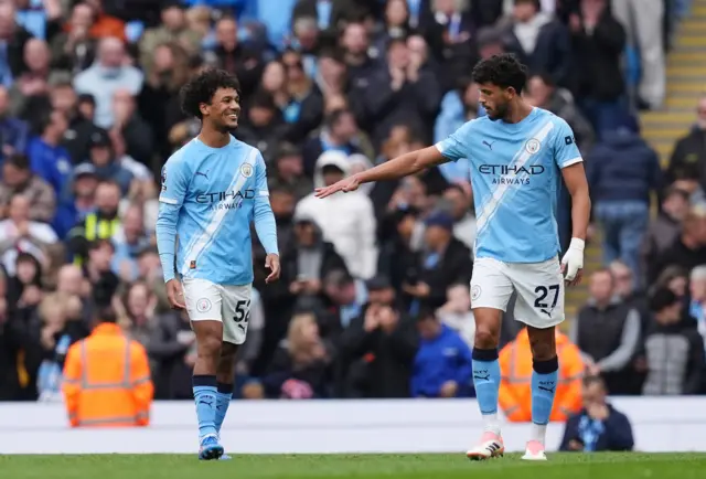 Manchester City's Oscar Bobb and Manchester City's Matheus Nunes celebrates their third goal