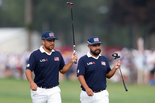 Xander Schauffele and JJ Spaun salute the crowd