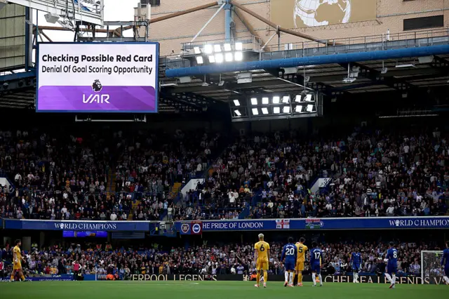 A message is displayed on the screen during a VAR review during the English Premier League football match between Chelsea and Brighton and Hove Albion at Stamford Bridge in London on September 27, 2025.