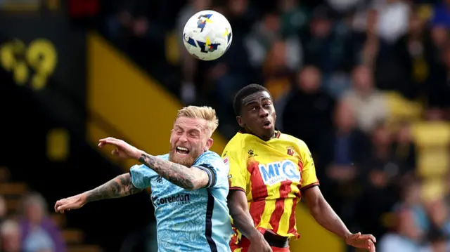 Oliver McBurnie of Hull City battles for a header with Kevin Keben of Watford