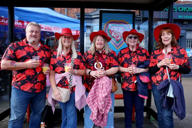A picture of England fans with roses shirts