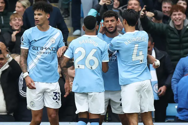 Manchester City's Portuguese midfielder #27 Matheus Nunes (2R) celebrates with teammates