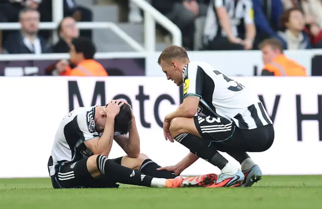 Tino Livramento of Newcastle United is consoled by teammate Dan Burn