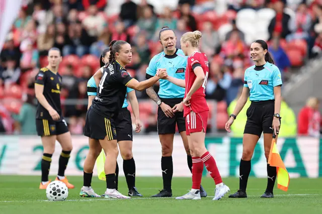 Captains, Grace Fisk of Liverpool and Maya Le Tissier of Manchester United shake hands before kick off prior to the Barclays Women's Super League match between Liverpool and Manchester United at Totally Wicked Stadium on September 28, 2025 in St Helens, England.