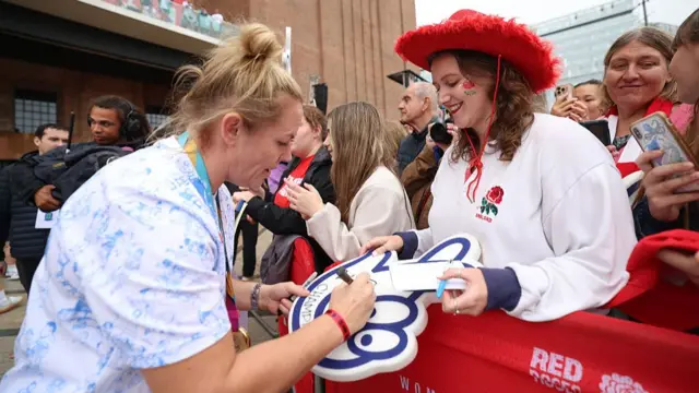 Marlie Packer signs a foam finger