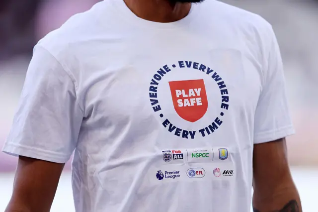 Detailed view of a ' Play Safe ' t-shirt worn by Aston Villa in the warm up ahead of he Premier League match between Aston Villa and Fulham at Villa Park on September 28, 2025 in Birmingham, England.