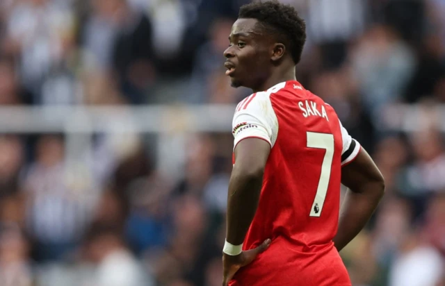 Bukayo Saka looks on