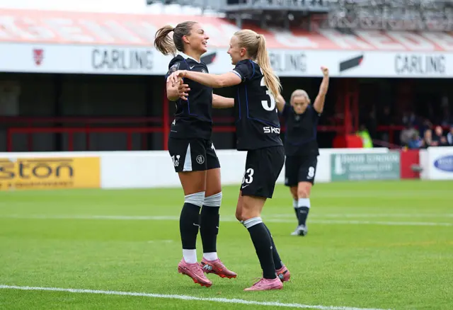 Johanna Rytting Kaneryd of Chelsea celebrates scoring her team's second goal with teammate Aggie Beever-Jones during the Barclays Women's Super League match between West Ham United and Chelsea FC at Chigwell Construction Stadium on September 28, 2025 in Dagenham, England.
