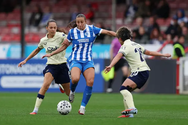 Rosa Kafaji of Brighton & Hove Albion is put under pressure by Martina Fernandez (L) and Nicole Momiki (R) of Everton during the Barclays Women's Super League match between Brighton & Hove Albion and Everton at Broadfield Stadium on September 28, 2025 in Crawley, England.