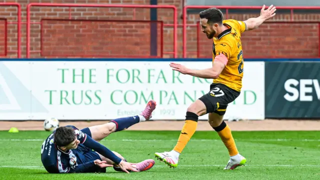 Livingston's Danny Wilson fouls Dundee's Charlie Reilly
