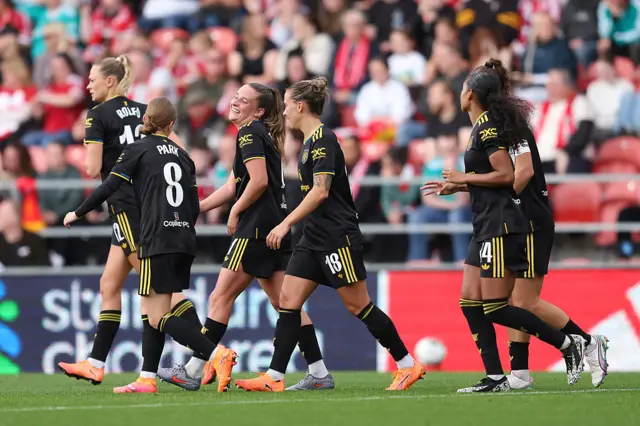 Ella Toone of Manchester United celebrates scoring her team's second goal with teammates during the Barclays Women's Super League match between Liverpool and Manchester United at Totally Wicked Stadium on September 28, 2025 in St Helens, England.