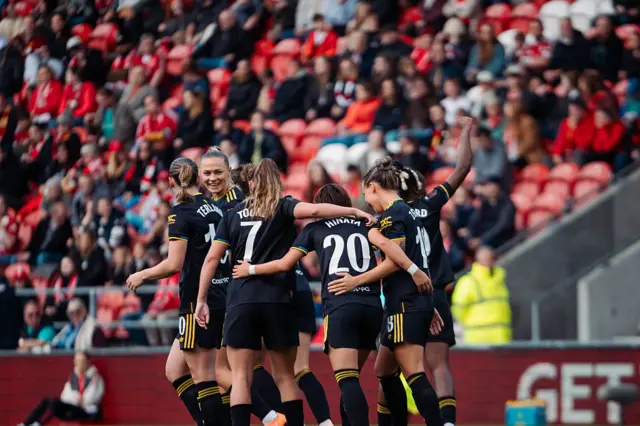 Hinata Miyazawa of Manchester United celebrates scoring a goal to make the score 0-1 with her team-mates during the Barclays Women's Super League match between Liverpool and Manchester United at Totally Wicked Stadium on September 28, 2025 in St Helens, England.