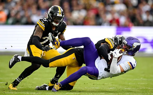 Wide receiver Adam Thielen #19 of Minnesota Vikings is tackled by Cornerback Brandin Echols #26 of Pittsburgh Steelers
