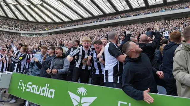 Newcastle fans celebrate the Champions League next season at the final whistle