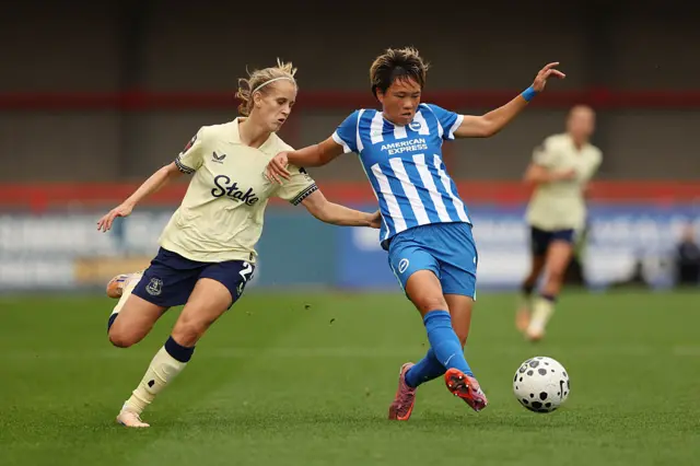 Moeka Minami of Brighton & Hove Albion is put under pressure by Katja Snoeijs of Everton during the Barclays Women's Super League match between Brighton & Hove Albion and Everton at Broadfield Stadium on September 28, 2025 in Crawley, England.