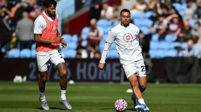 Tyrone Mings (L) and Morgan Rogers of Aston Villa (R) warm up