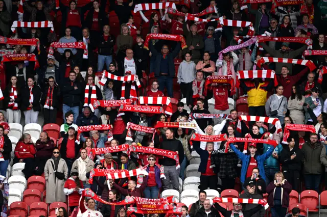 Liverpool fans hold up scarfs while singing 'You'll Never Walk Alone' before the Barclays Women's Super League match at the Totally Wicked Stadium, St Helens.