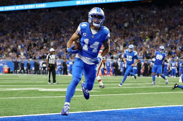 Amon-Ra St. Brown #14 of the Detroit Lions scores a touchdown during the second quarter against the Cleveland Browns